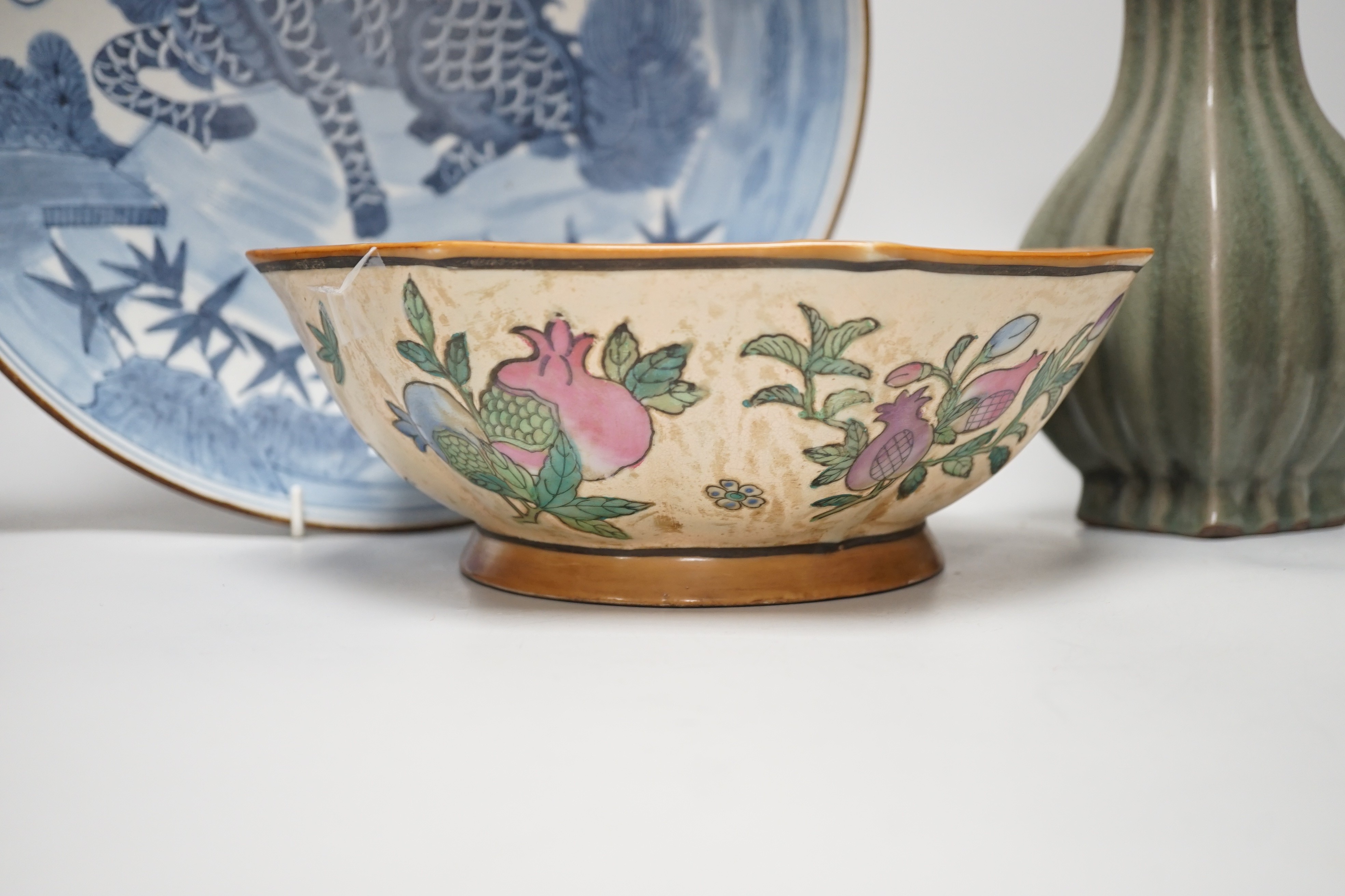 A Chinese blue and white ‘qilin’ dish, an octagonal bowl and a Korean celadon vase (3) largest 33cm diameter